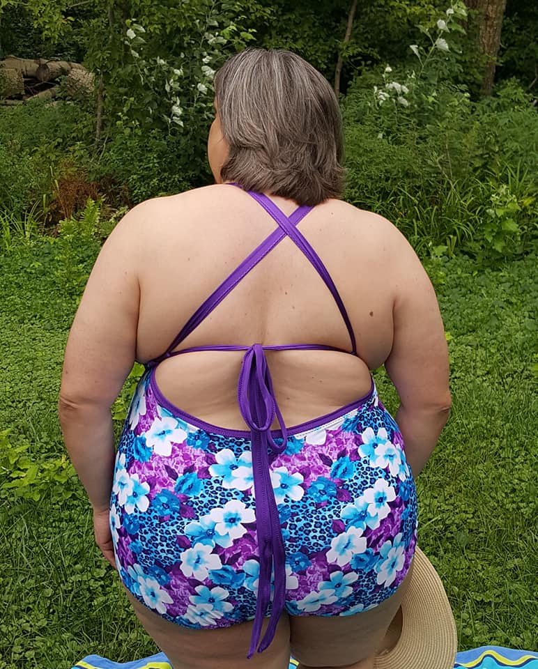 Back view of the Annette swimsuit. The pattern is a colorful floral design. Features cross-x, adjustable back straps. 