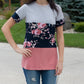 A long t-shirt Nicolette featuring a crew neck, short sleeves, and color blocking. 