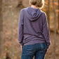 Back view of the Melissa Sweatshirt in misses size. Features a hood and banded hem. 