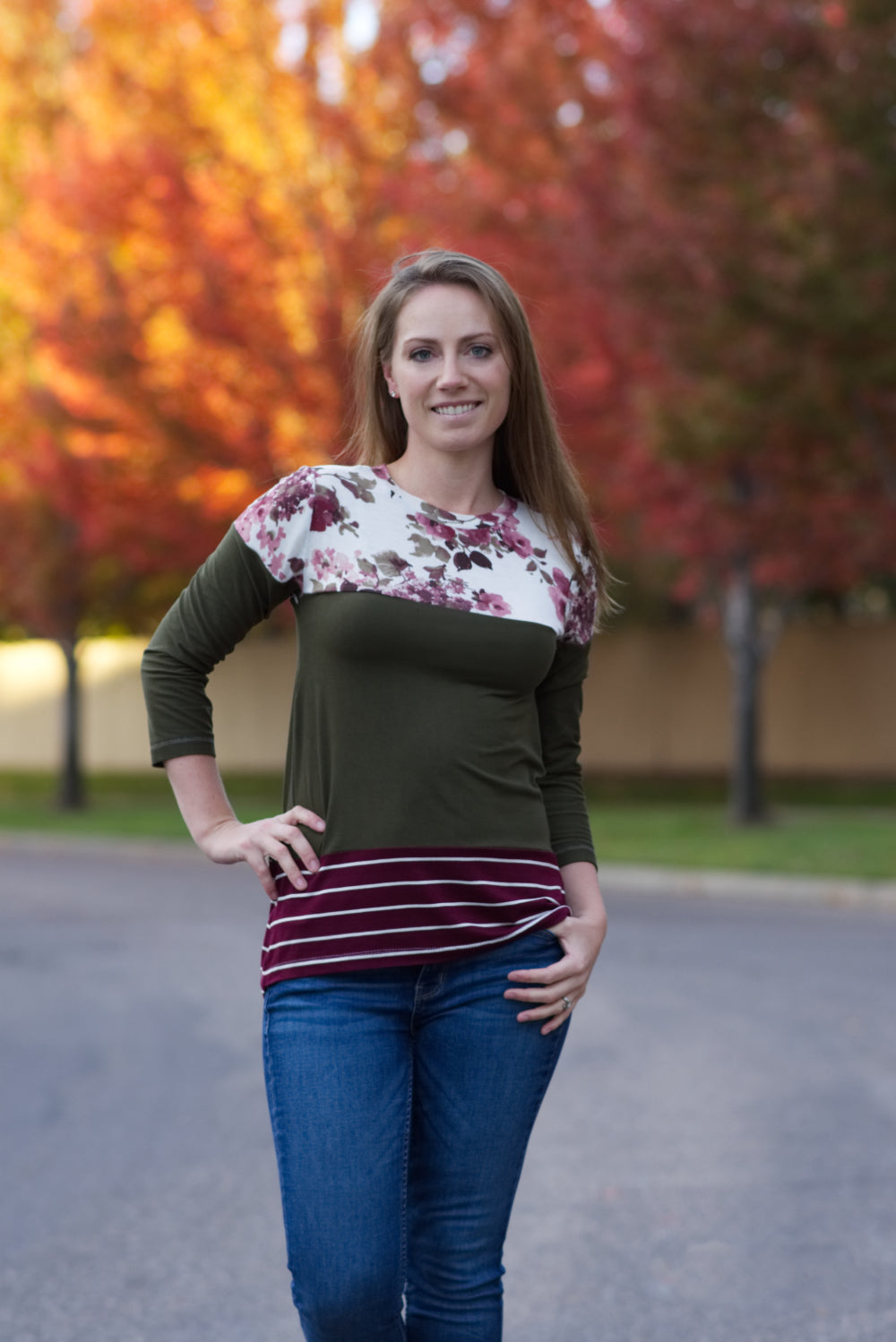 A long t-shirt length Nicolette featuring a crew neck, color blocking, and 3/4 length sleeves. 