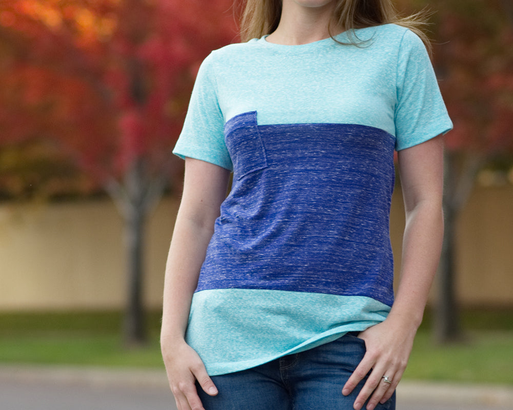 Close up of the Nicolette colorblocked t-shirt. Features a crew neck, three color-blocked panels, short sleeves, a breast pocket, and t-shirt length pattern options. 