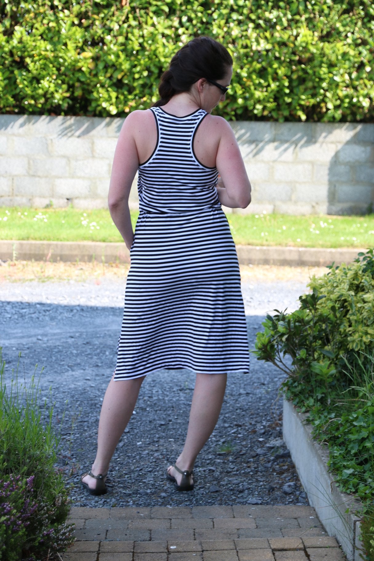 Back view of the Helen Dress. Features a racerback bodice and knee-length skirt. 