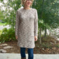 A mid-thigh length Nicolette dress with crew neck and long sleeves. 