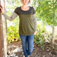 A tunic-length Nicolette shirt with a scoop neck, long sleeves, and color blocking details. 