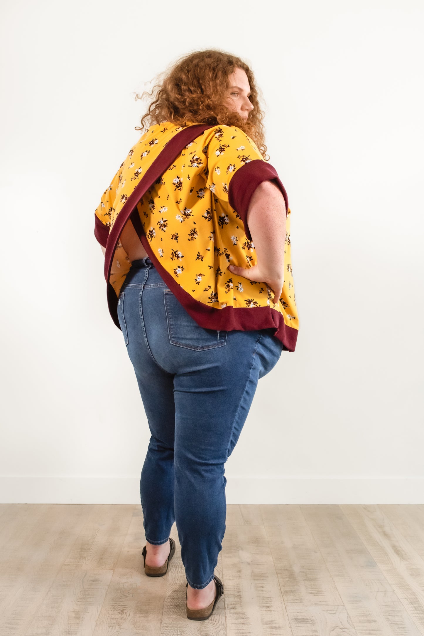 Back view of the Madam Tulip Crossback Sweatshirt in Plus size, featuring short sleeves and long bodice length.