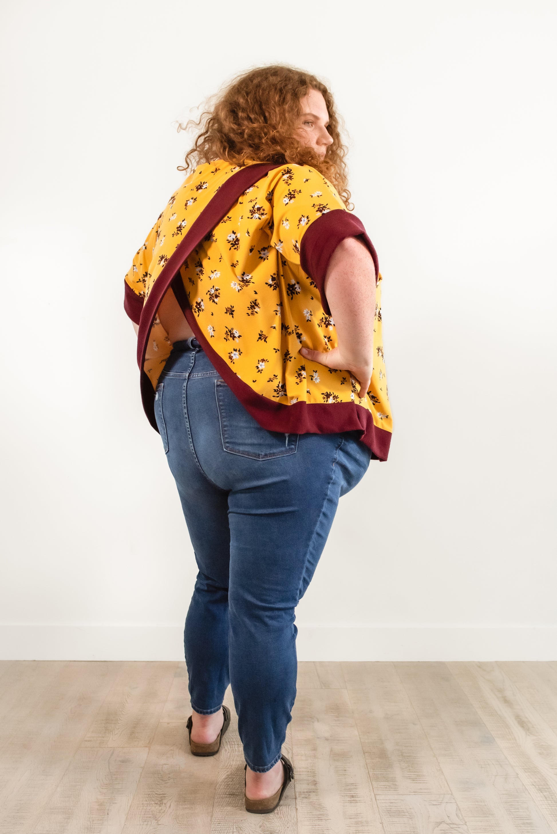 Back view of the Madam Tulip Crossback Sweatshirt in Plus size, featuring short sleeves and long bodice length.