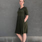 Emmeline with scoop neck, elbow-length sleeves, pockets, and knee-length skirt. Misses size. 
