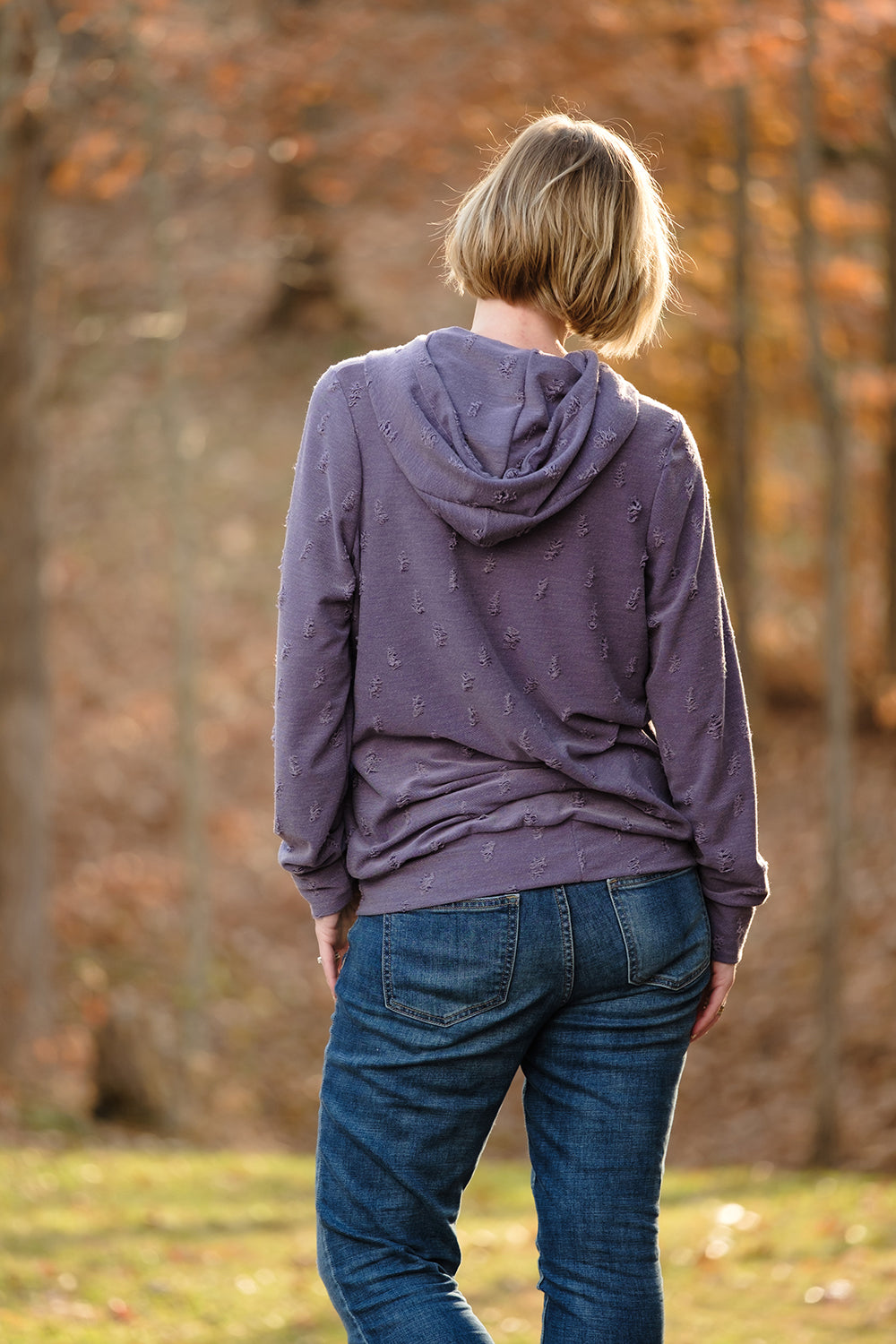 Back view of the Melissa Sweatshirt in misses size. Features a hood and banded hem. 