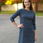 A mid-thigh length Nicolette dress featuring a crew neck and 3/4 length sleeves. 
