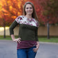 A long t-shirt length Nicolette featuring a crew neck, color blocking, and 3/4 length sleeves. 
