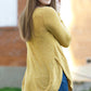 Back and side angle view of a woman wearing a mustard yellow knit DIBY Club Adrianne Sweater