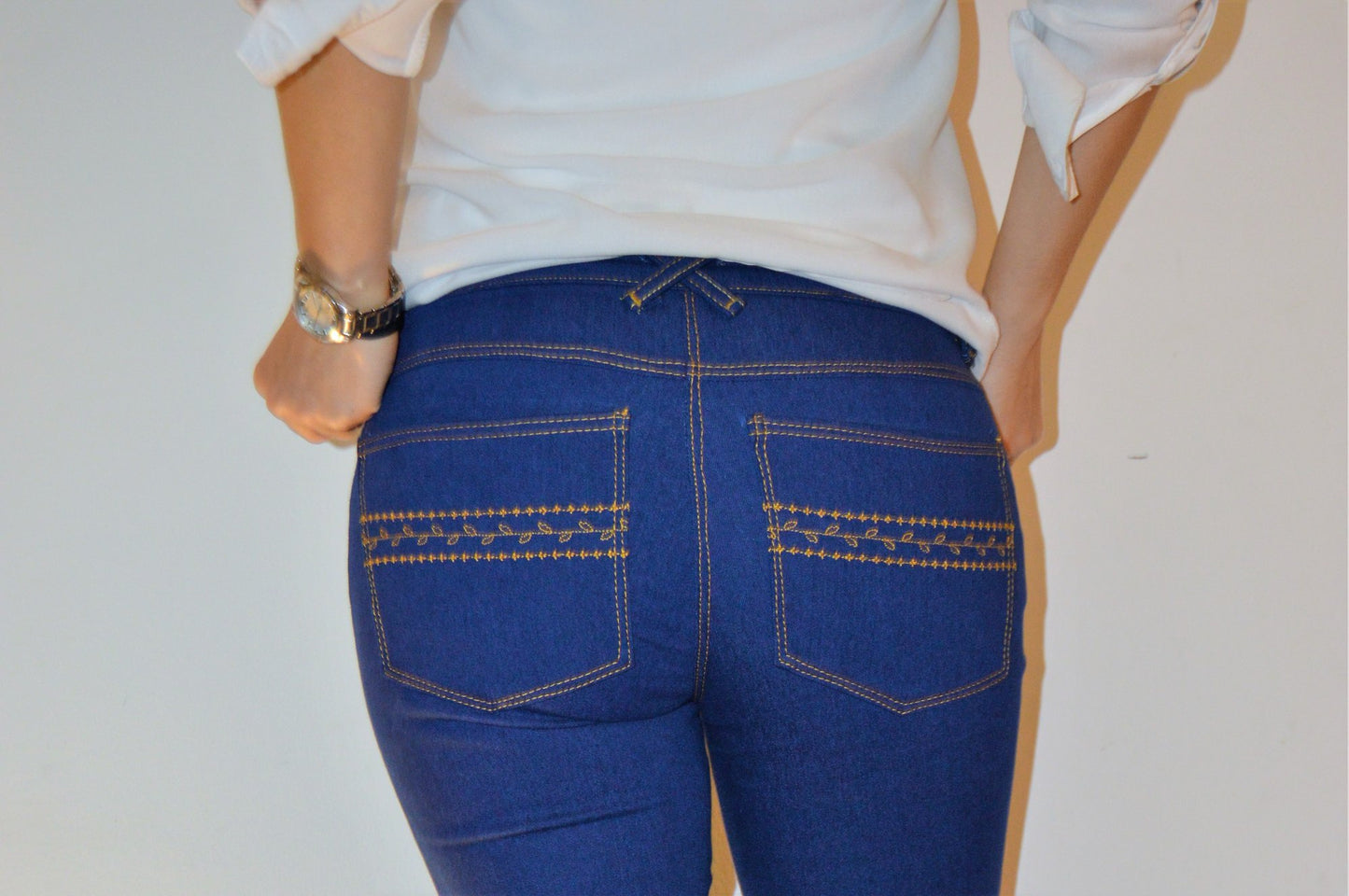 Closeup view of back pockets with decorative stitching