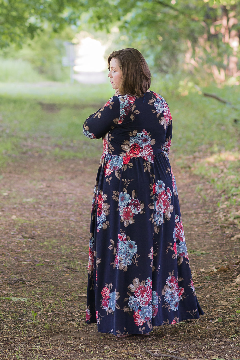 Back view of the Emmeline in plus size, featuring long sleeves and maxi-length skirt. 