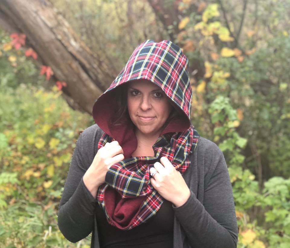 Hooded infinity pattern tester. Features a hood up with a plaid design and merlot-colored lining. 