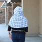 Pattern tester for Infinity Scarf Pattern. Back view. Hood is up. Main fabric and lining are a blue and white pattern. 