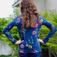 Girl in a long sleeve tee with blue flower pattern fabric