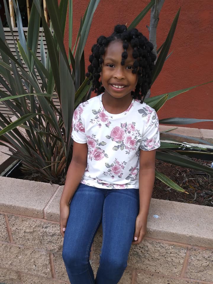 Young black girl in a rose pattern t-shirt