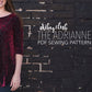 Woman wearing 3/4 sleeve red crushed velvet DIBY Club Adrianne Sweater in front of a dark brick wall. Words read diby.club The Adrianne PDF Sewing Pattern